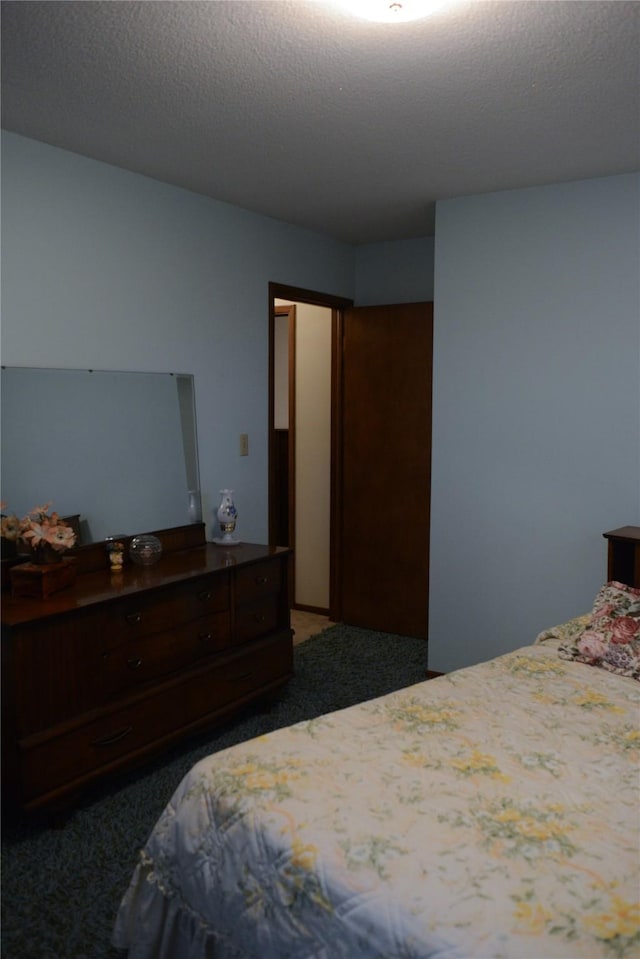 carpeted bedroom with a textured ceiling