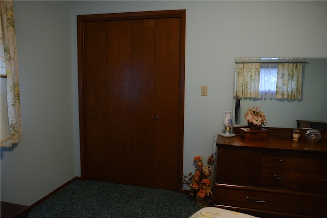 carpeted bedroom with a closet