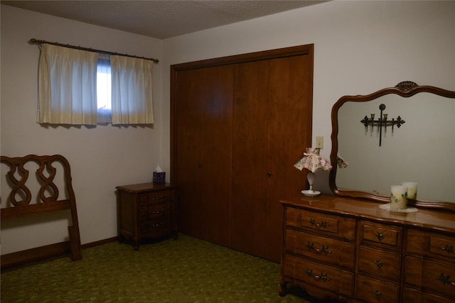 bedroom featuring dark colored carpet and a closet