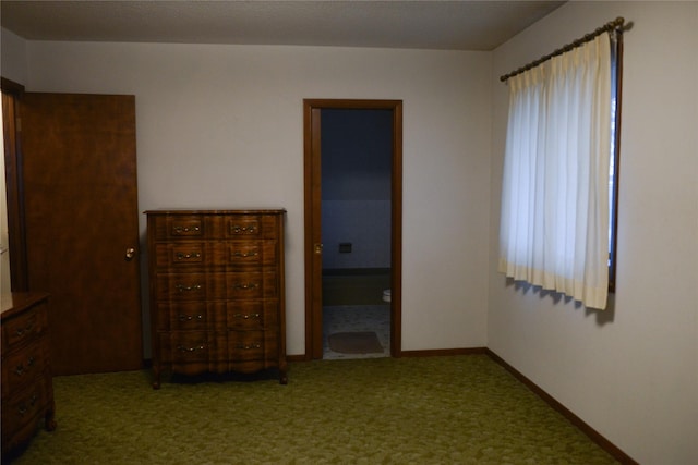 unfurnished bedroom with carpet and ensuite bathroom