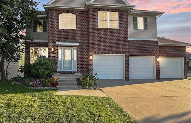 view of front of home with a lawn and a garage