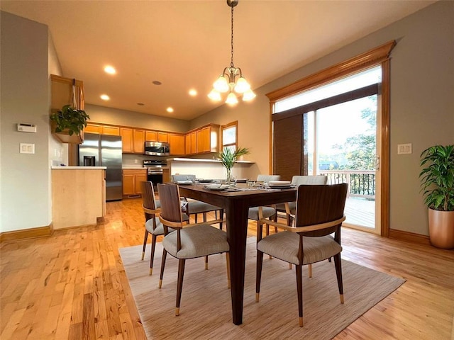 dining area featuring a notable chandelier and light hardwood / wood-style floors