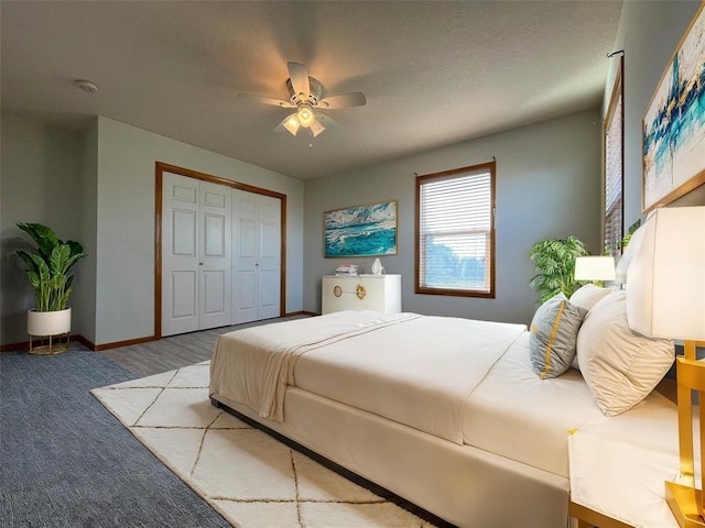 bedroom with ceiling fan, a closet, and light carpet