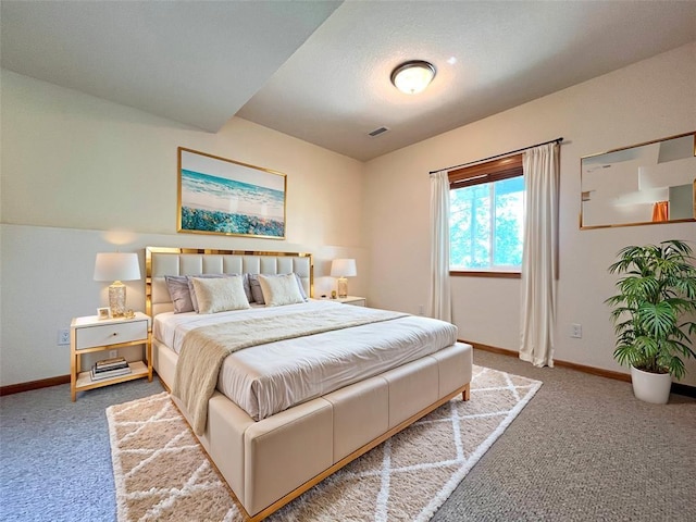 carpeted bedroom with lofted ceiling