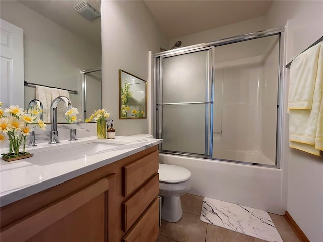 full bathroom featuring tile patterned floors, vanity, toilet, and shower / bath combination with glass door