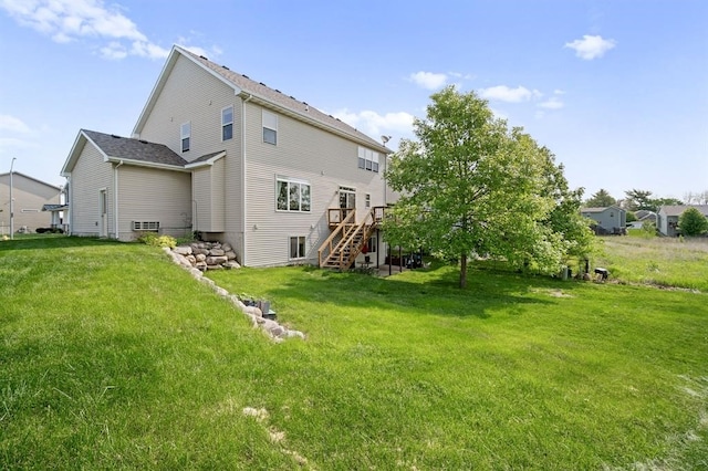 rear view of property featuring a deck and a yard