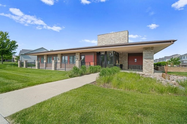 rear view of property with a lawn