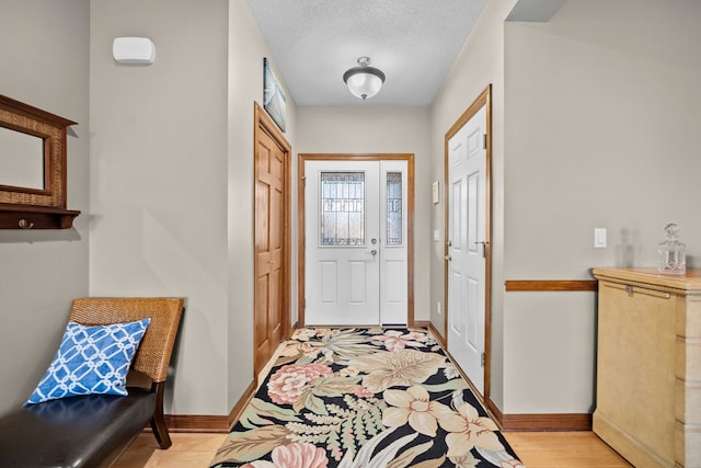 entrance foyer featuring light hardwood / wood-style floors and a textured ceiling