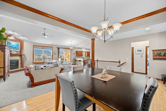 dining space with ceiling fan with notable chandelier, light hardwood / wood-style floors, and ornamental molding