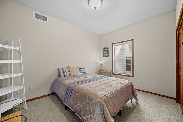 carpeted bedroom featuring a textured ceiling