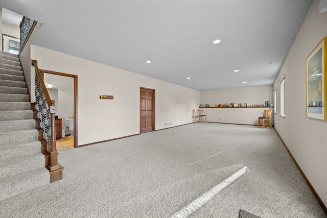 unfurnished living room with light colored carpet