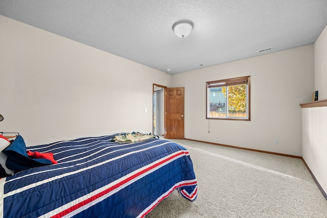 bedroom featuring carpet floors and a textured ceiling