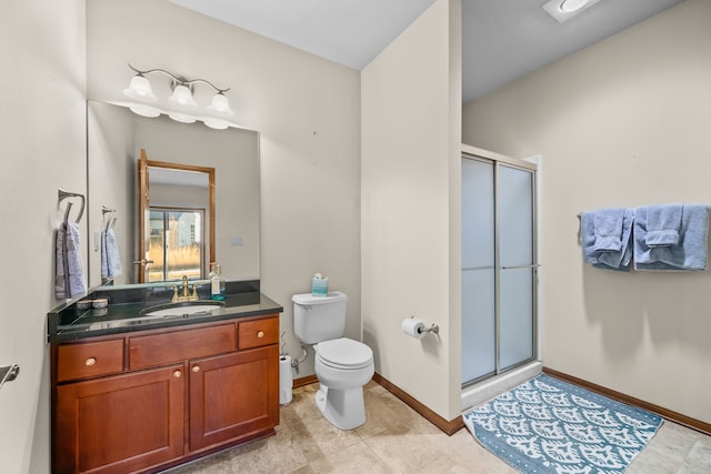 bathroom featuring toilet, vanity, and walk in shower