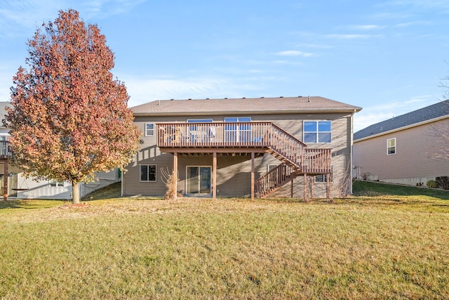 rear view of house with a deck and a yard