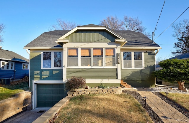 view of front of house with cooling unit and a garage