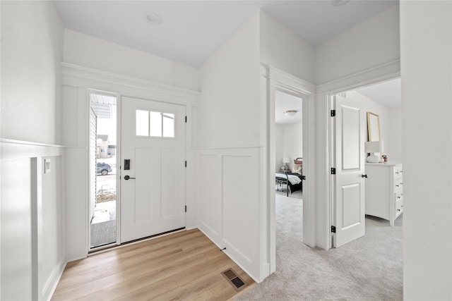 foyer entrance with light hardwood / wood-style flooring