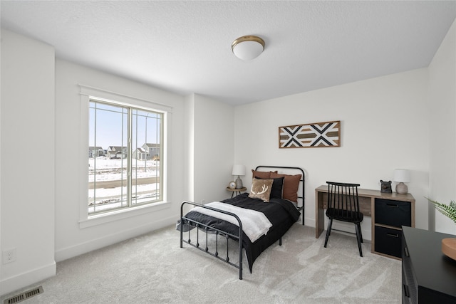 carpeted bedroom featuring a textured ceiling