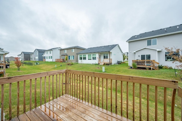 wooden terrace with a yard