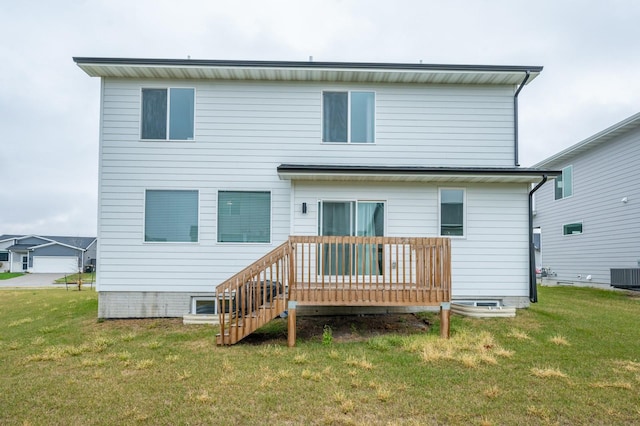 rear view of house with a lawn, central air condition unit, and a wooden deck