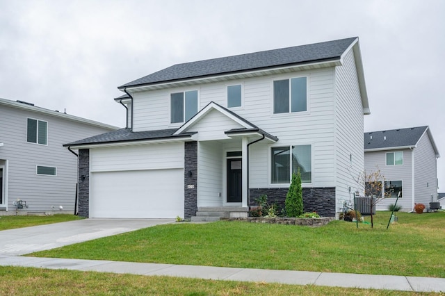 view of front of home with a garage and a front lawn