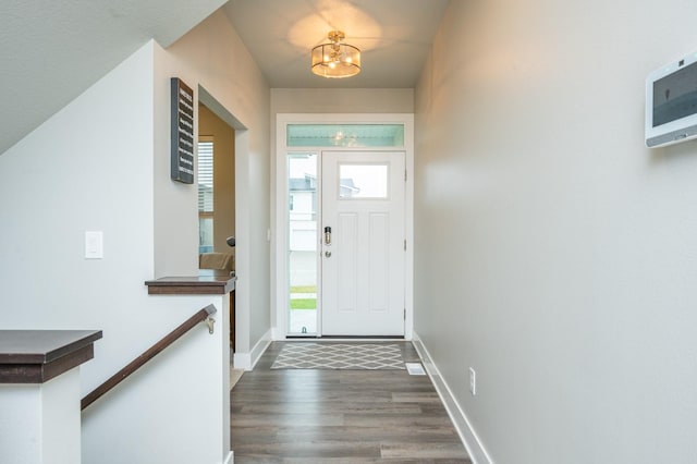 entrance foyer with a chandelier and dark hardwood / wood-style flooring