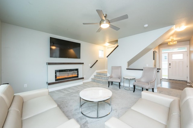 living room featuring hardwood / wood-style floors and ceiling fan