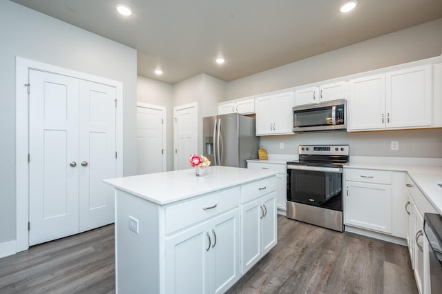 kitchen with a kitchen island, white cabinets, and appliances with stainless steel finishes