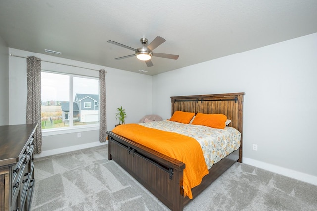 bedroom with light carpet and ceiling fan