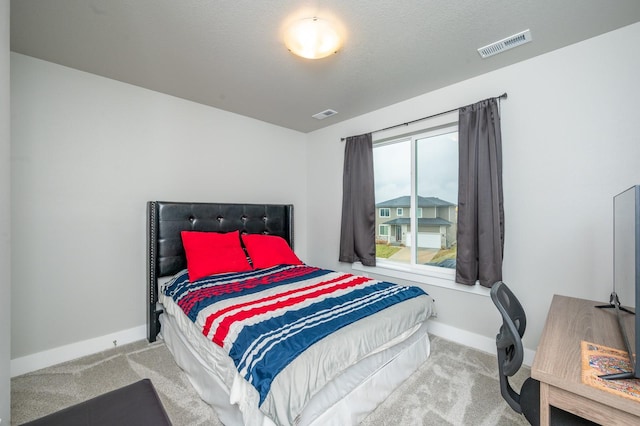 carpeted bedroom with a textured ceiling