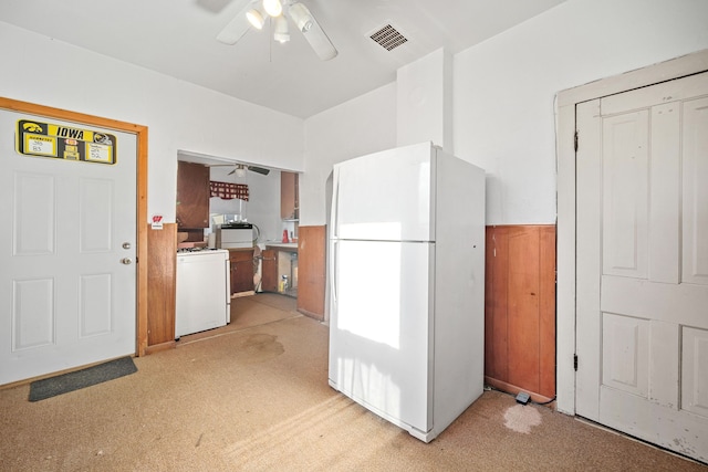 104 2nd Ave, Bagley, IA 50026 - kitchen with ceiling fan, white fridge, light carpet, and washer / clothes dryer