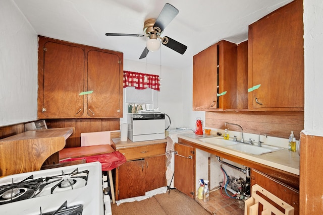 104 2nd Ave, Bagley, IA 50026 - kitchen with tasteful backsplash, ceiling fan, sink, and white range with gas stovetop