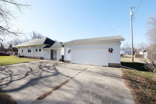 single story home with a garage and a front lawn