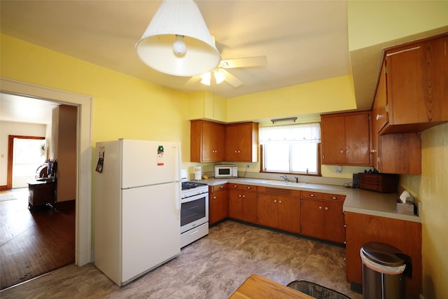 kitchen with ceiling fan, sink, light hardwood / wood-style floors, and white appliances