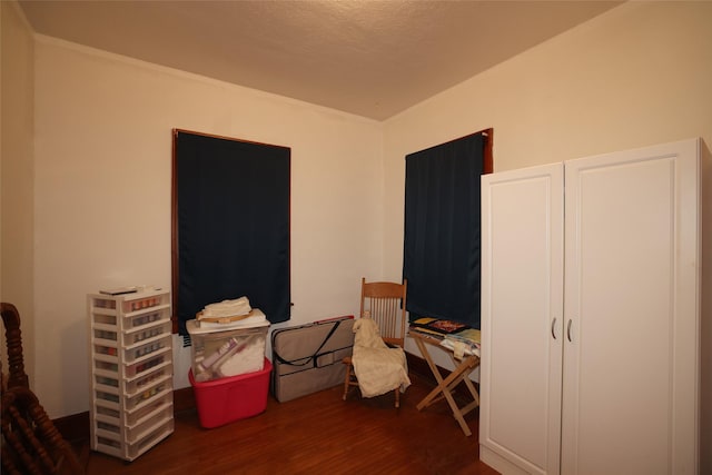 bedroom with dark hardwood / wood-style floors