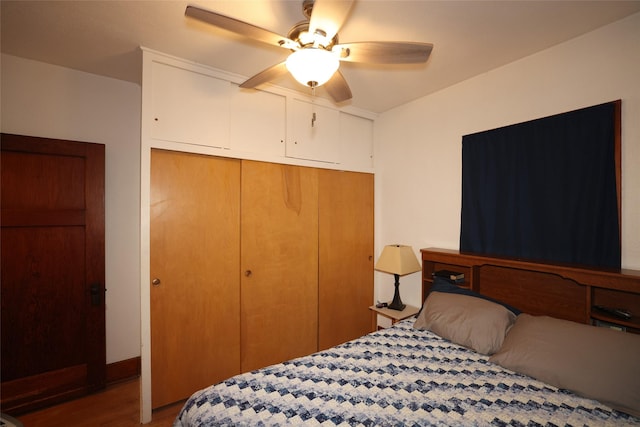 bedroom with a closet, ceiling fan, and hardwood / wood-style floors