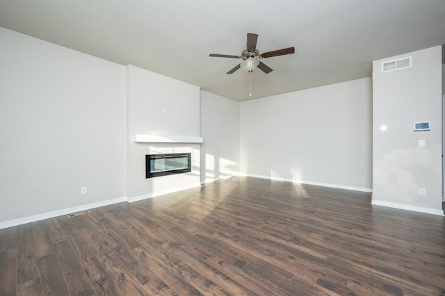 unfurnished living room with ceiling fan and dark hardwood / wood-style flooring