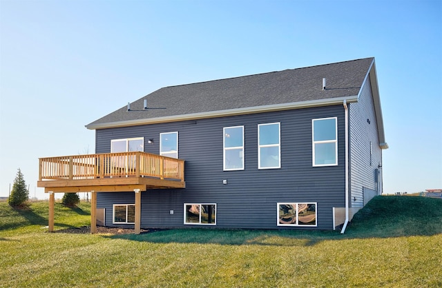 rear view of house with a yard and a deck