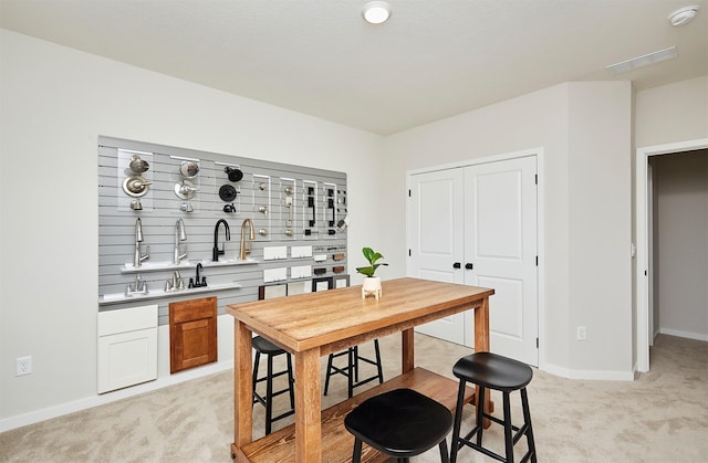 kitchen with light colored carpet