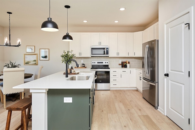 kitchen with white cabinetry, sink, and appliances with stainless steel finishes