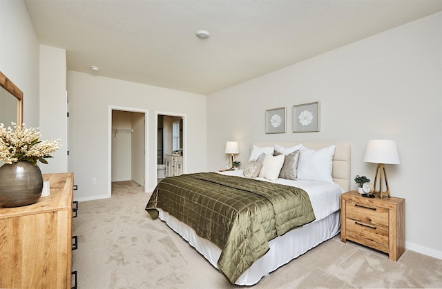 carpeted bedroom featuring a walk in closet