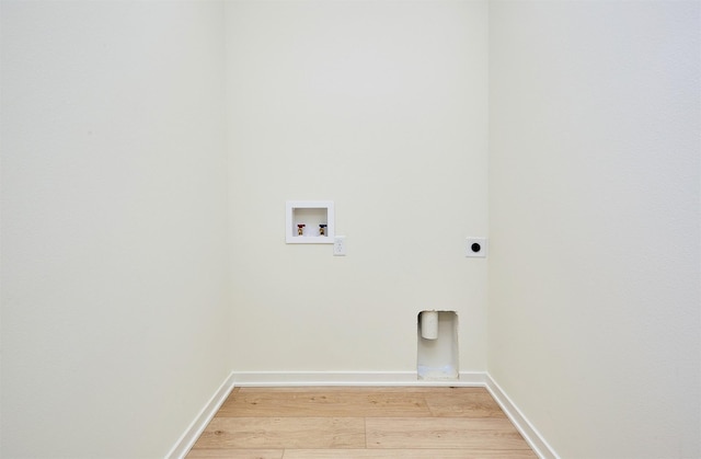 washroom featuring hookup for an electric dryer, hookup for a washing machine, and wood-type flooring