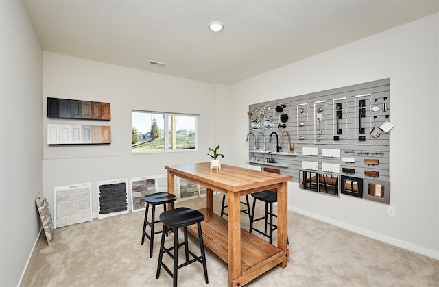 dining area with light colored carpet