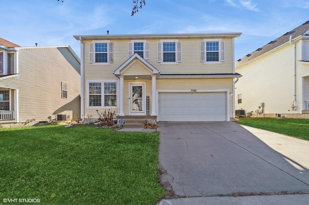 view of front of property featuring a garage and a front lawn