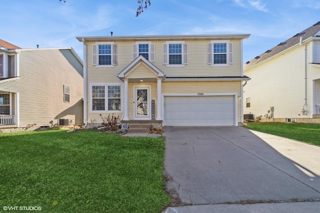 view of front of property featuring a garage and a front lawn