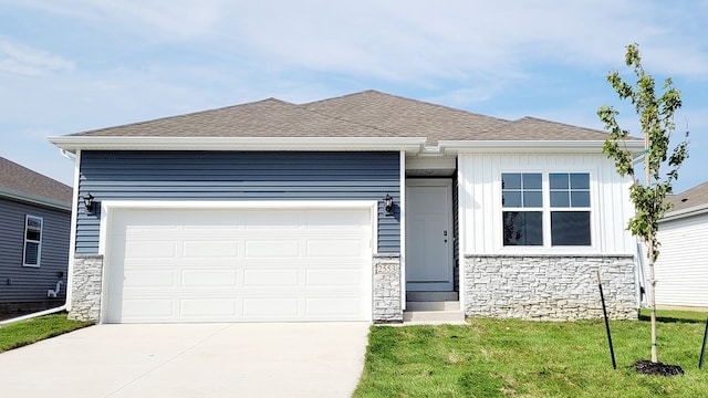 view of front of property with a garage and a front lawn