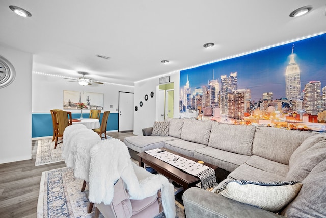 living room featuring wood-type flooring and ceiling fan