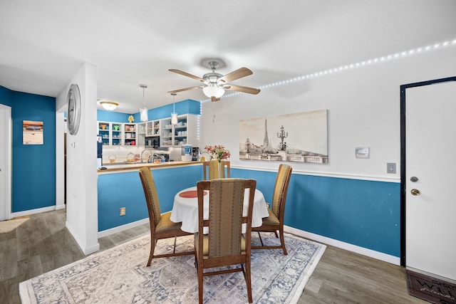 dining area with hardwood / wood-style flooring and ceiling fan