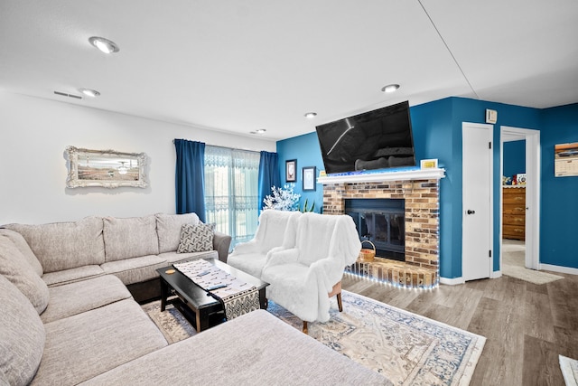 living room featuring a fireplace and hardwood / wood-style floors