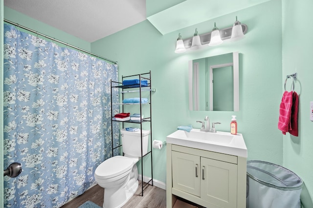 bathroom featuring hardwood / wood-style floors, vanity, toilet, and curtained shower