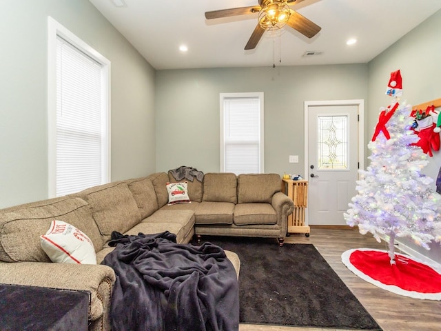 living room with ceiling fan and hardwood / wood-style flooring